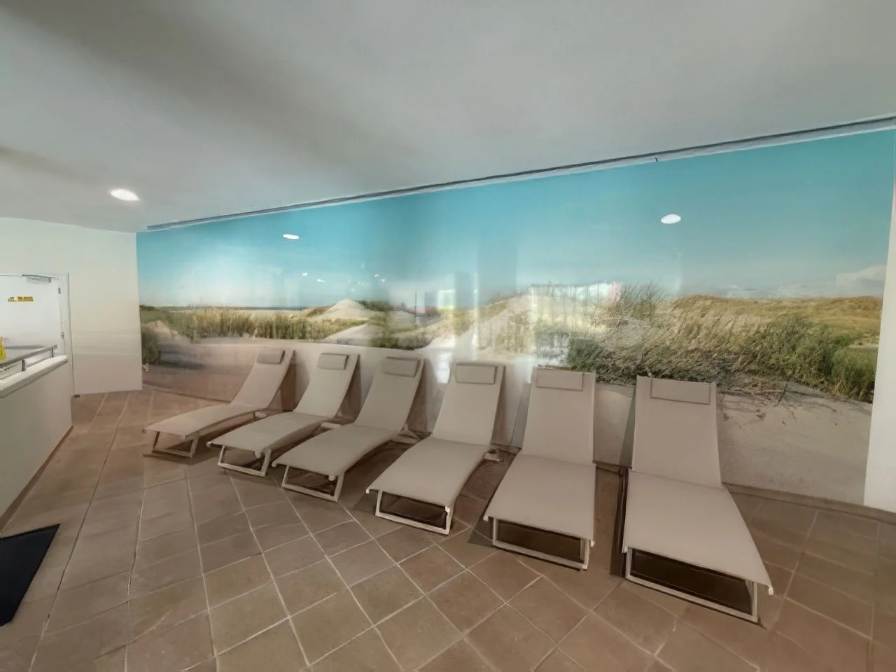 Swimming pool-side area with tiled floor, 6 loungers and panoramic sand dunes image wall panels
