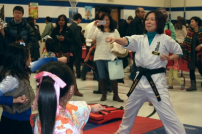 Sensei Etsuko is teaching karate to students from Thomas Dooley Elementary School for Japanese Cultural Night.