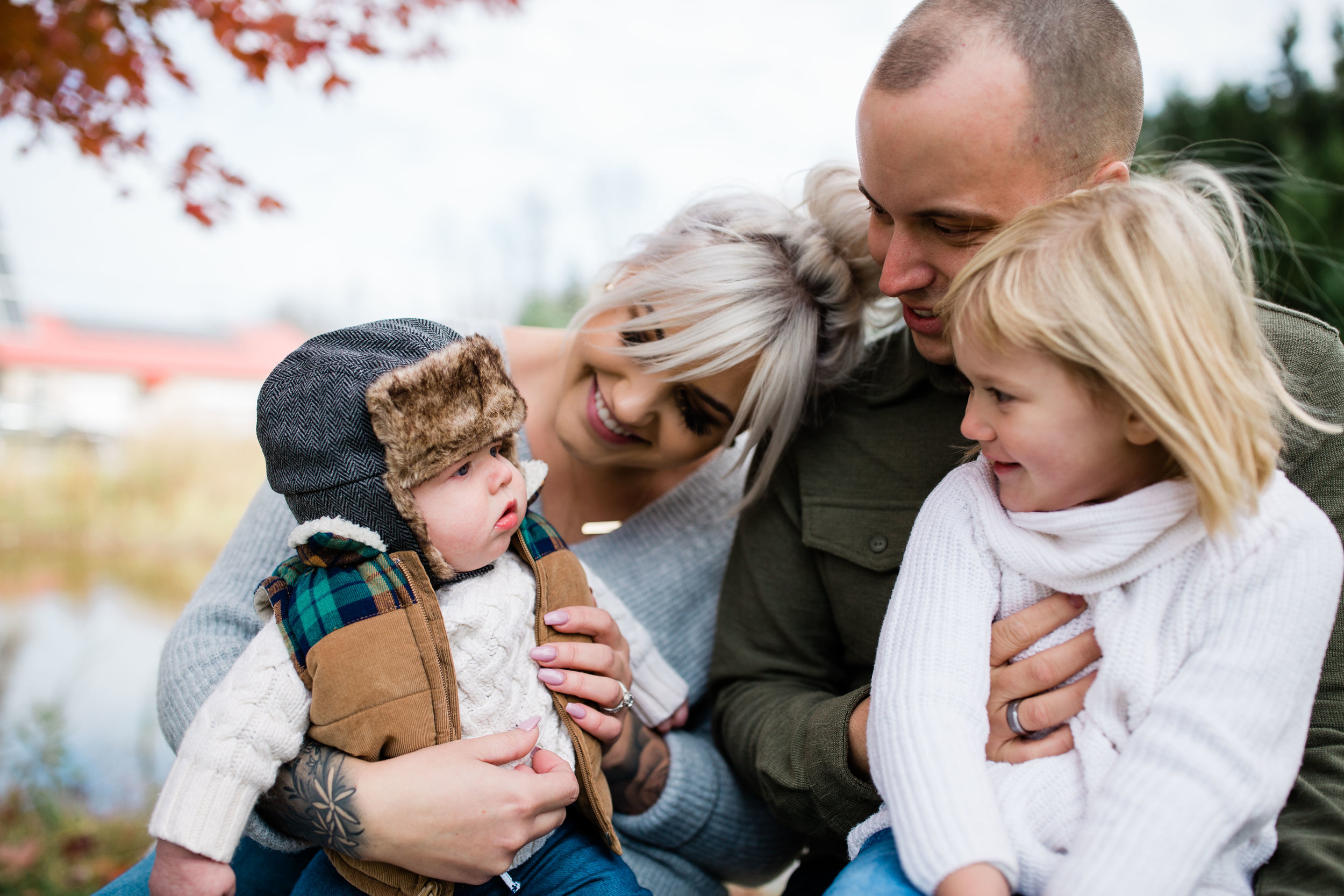 Ali's smiling family of 4 bundled for fall.