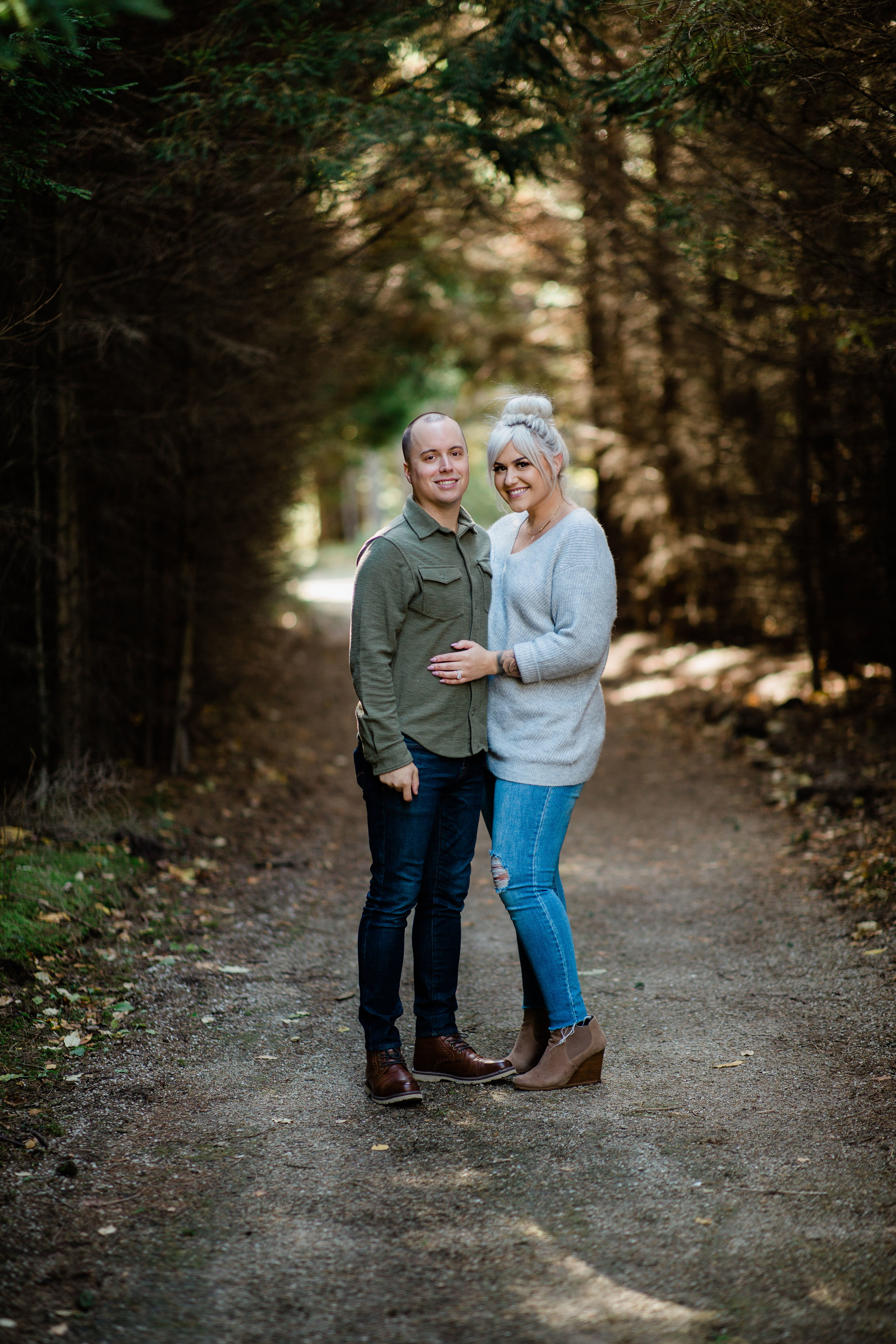 Parents family formal on gravel trail in woods.