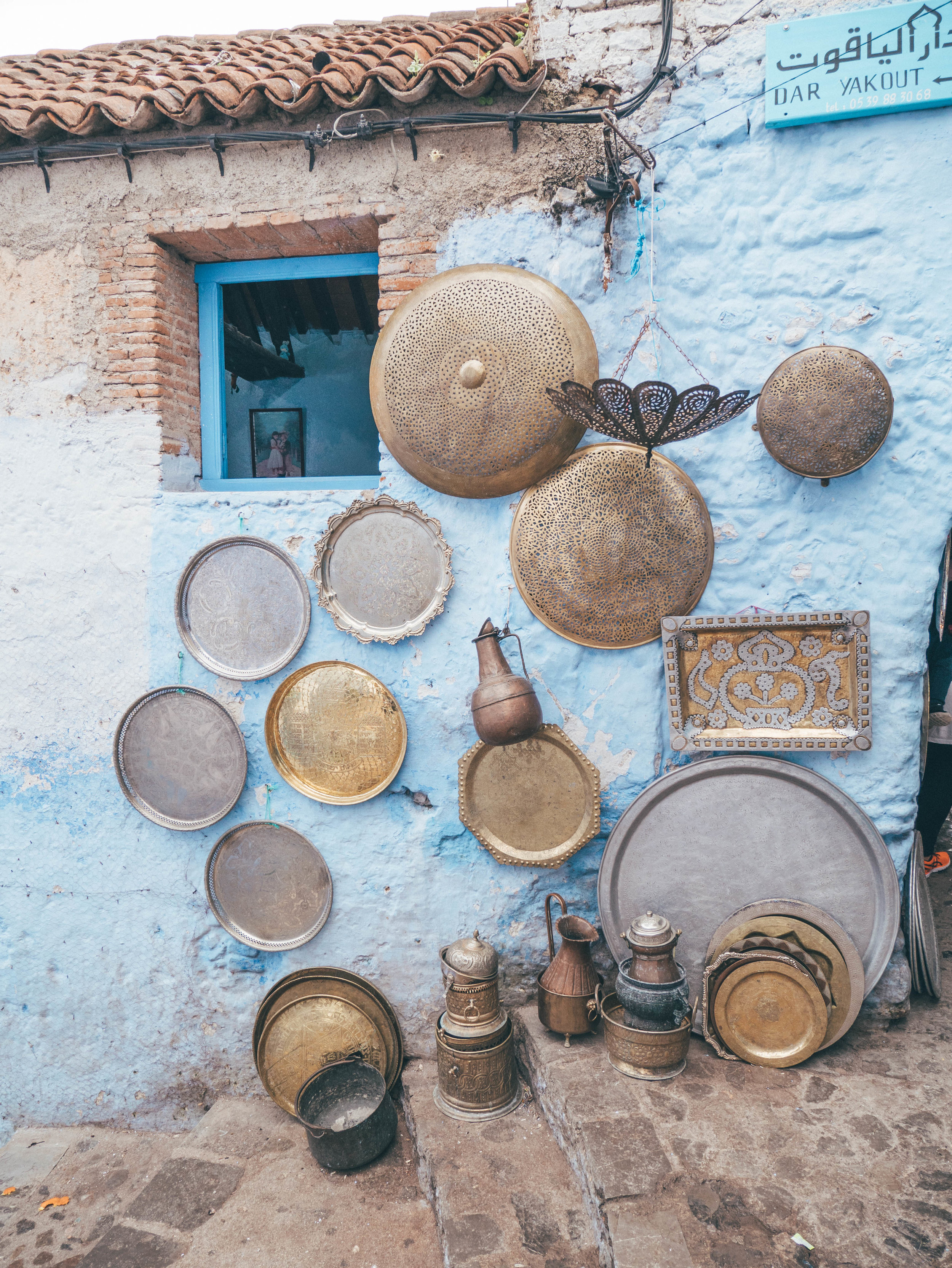 Silver plates on a blue house wall - Chefchaouen - Morocco