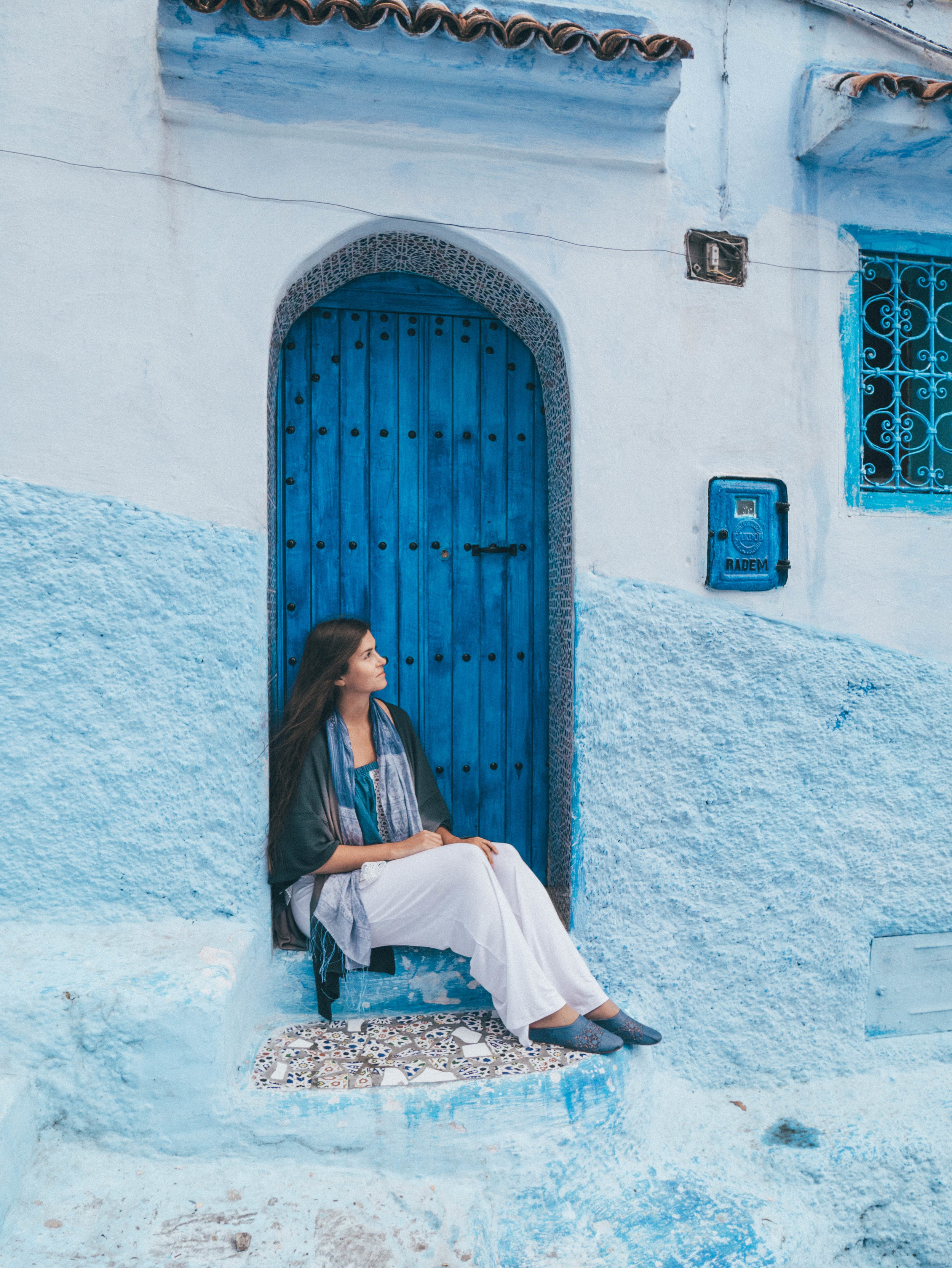 Me sitting on someone's door - Chefchaouen - Morocco