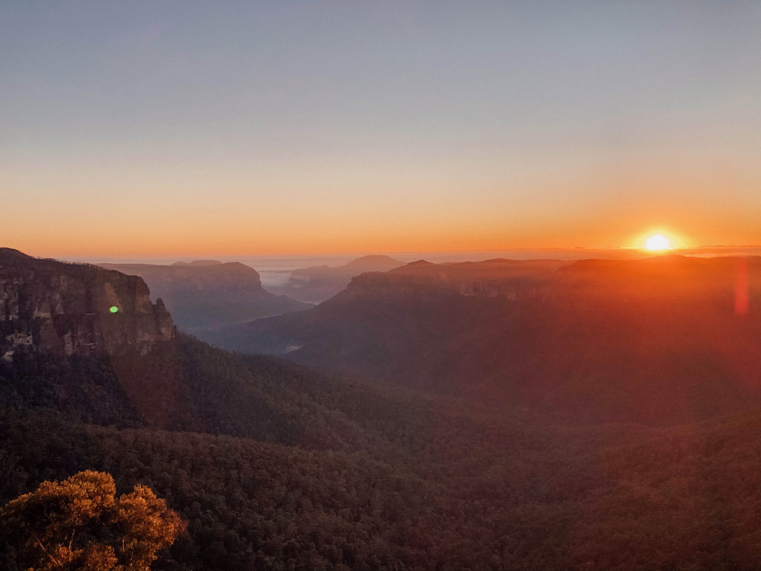 The sun rising behind the mountain in Blackheath - Blue Mountains - New South Wales (NSW) - Australia