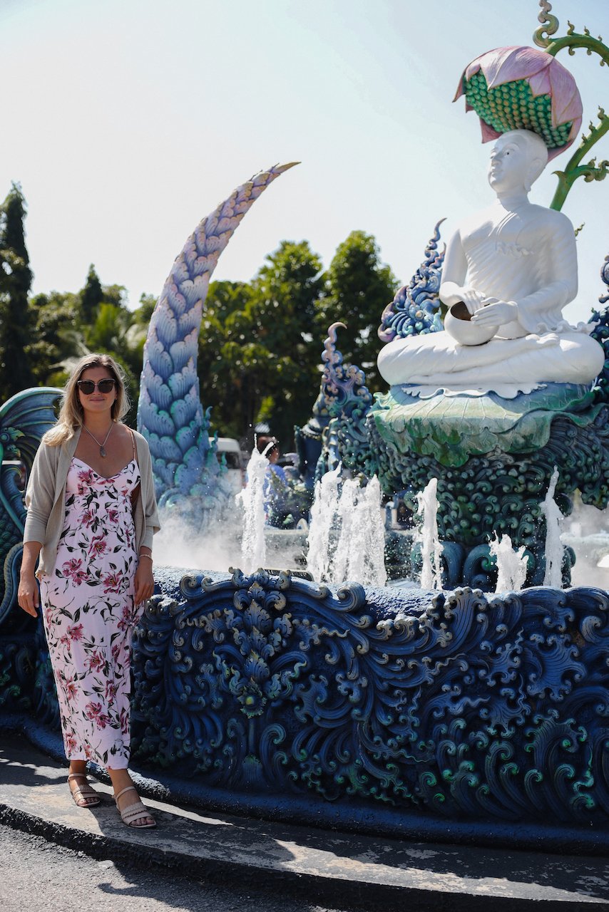 Femme qui pose devant la fontaine en face du temple - Temple Bleu  - Wat Rong Suea Ten - Chiang Rai - Nord de la Thaïlande