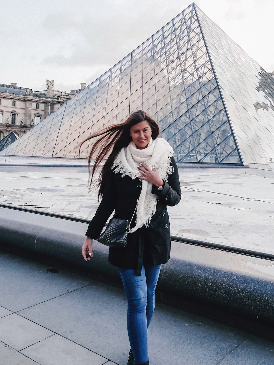 Woman posing in front of the Louvre Pyramid - Paris - France