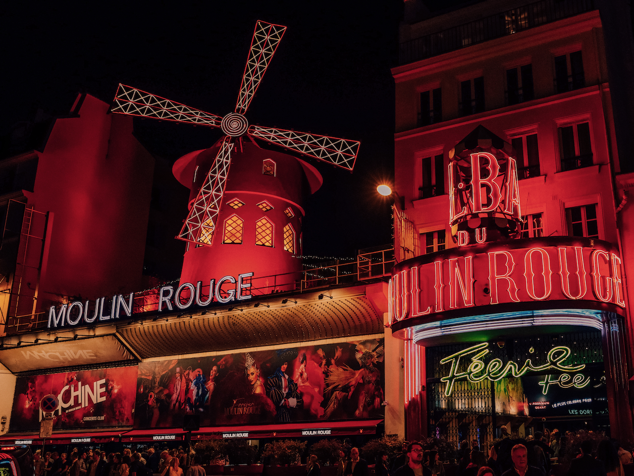 The stunning facade of the Moulin Rouge lit up at night - Paris - France
