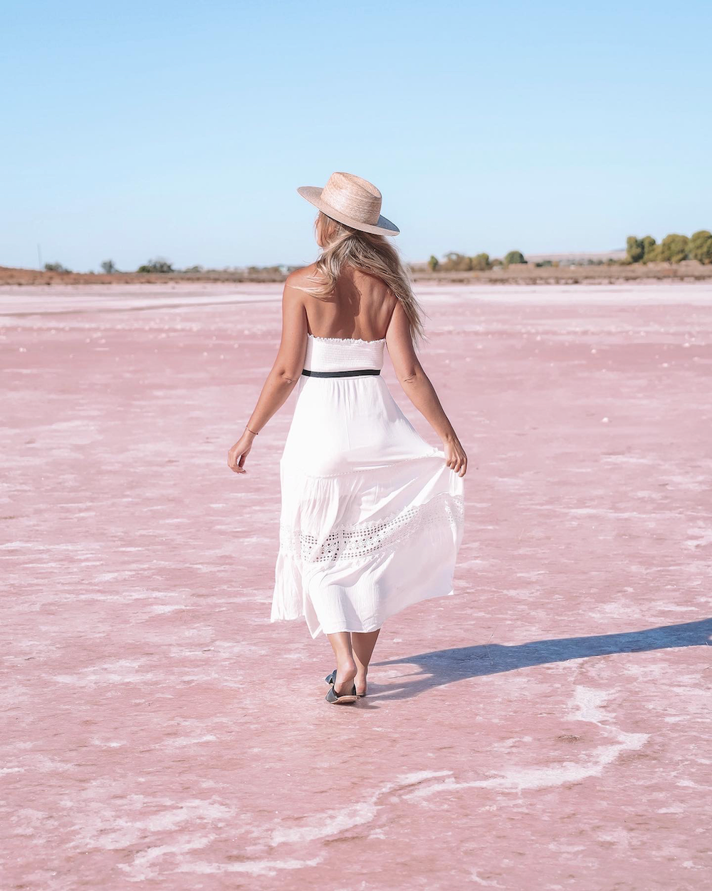 Blond woman walking on pink Bumbunga Lake - South Australia (SA) - Australia