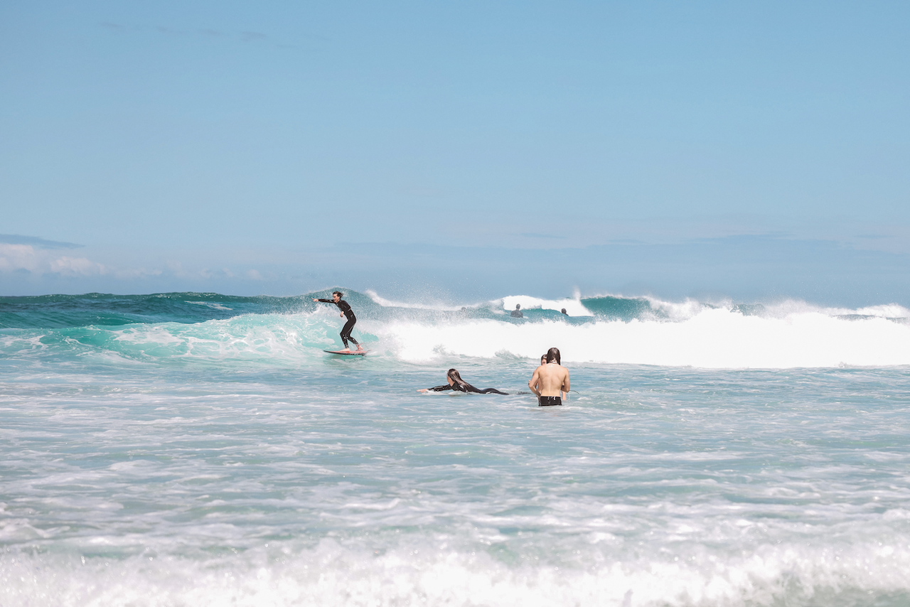 Kids surfing in the waves at Tallow Beach - Byron Bay - New South Wales - Australia