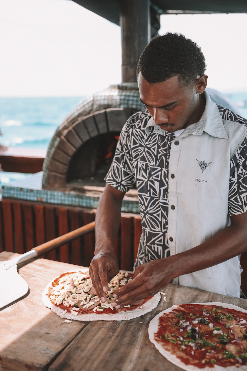 Man preparing woodfired pizzas at Cloud 9 floating bar - Mamanuca Islands - Fiji