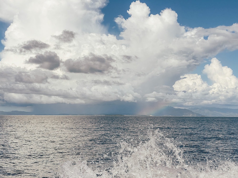 Boat ride and rainbow in the background - Mamanuca Islands - Fiji