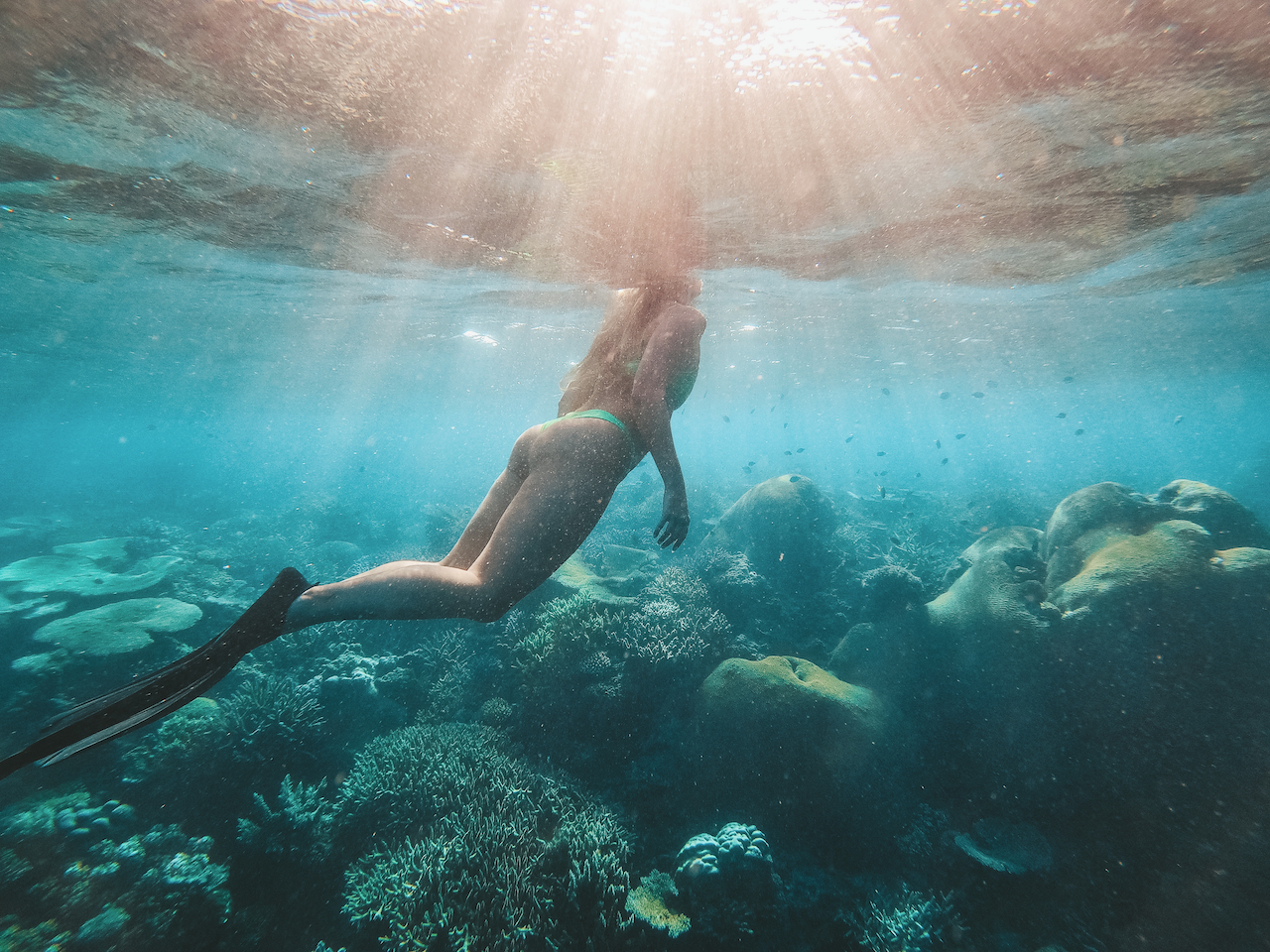 Girl snorkeling with sun reflection in underwater - Barefoot Manta Resort - Yasawa Islands - Fiji