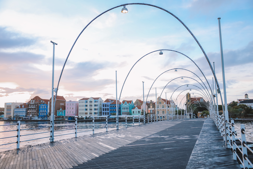 Stunning Queen Emma Bridge with colourful houses in the background at sunrise - Willemstad - Curaçao - ABC Islands