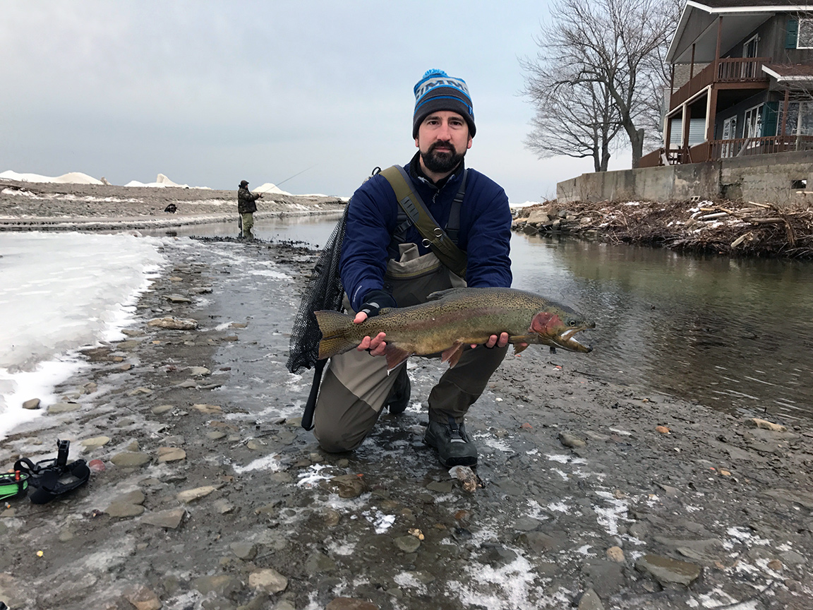 Holding the 28" male steelhead I caught, looking like I haven't slept in days.