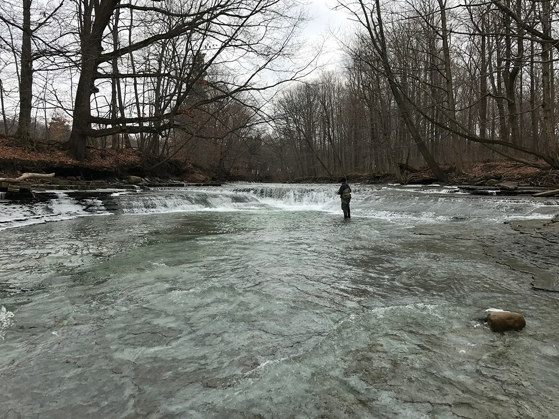 Jon fly fishing the heavy water at the Walnut Creek waterfall.