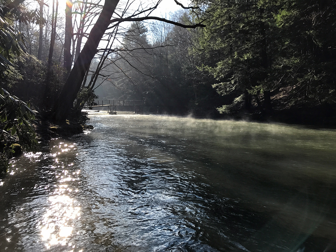 The fog lifts off of Yellow Creek as the sun hits the water.