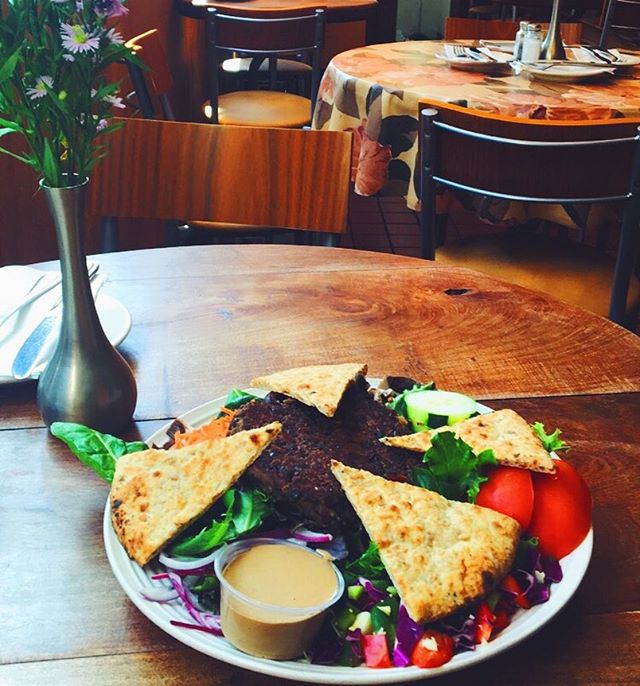Our mouth watering black bean burger special over a garden salad topped with pita😍😋