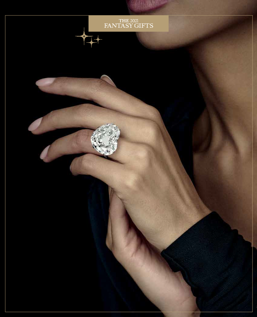 Close-up of a woman's hand with a large diamond ring, lips, and part of her face visible, against a dark background. The image is labeled "The 2021 Fantasy Gifts."