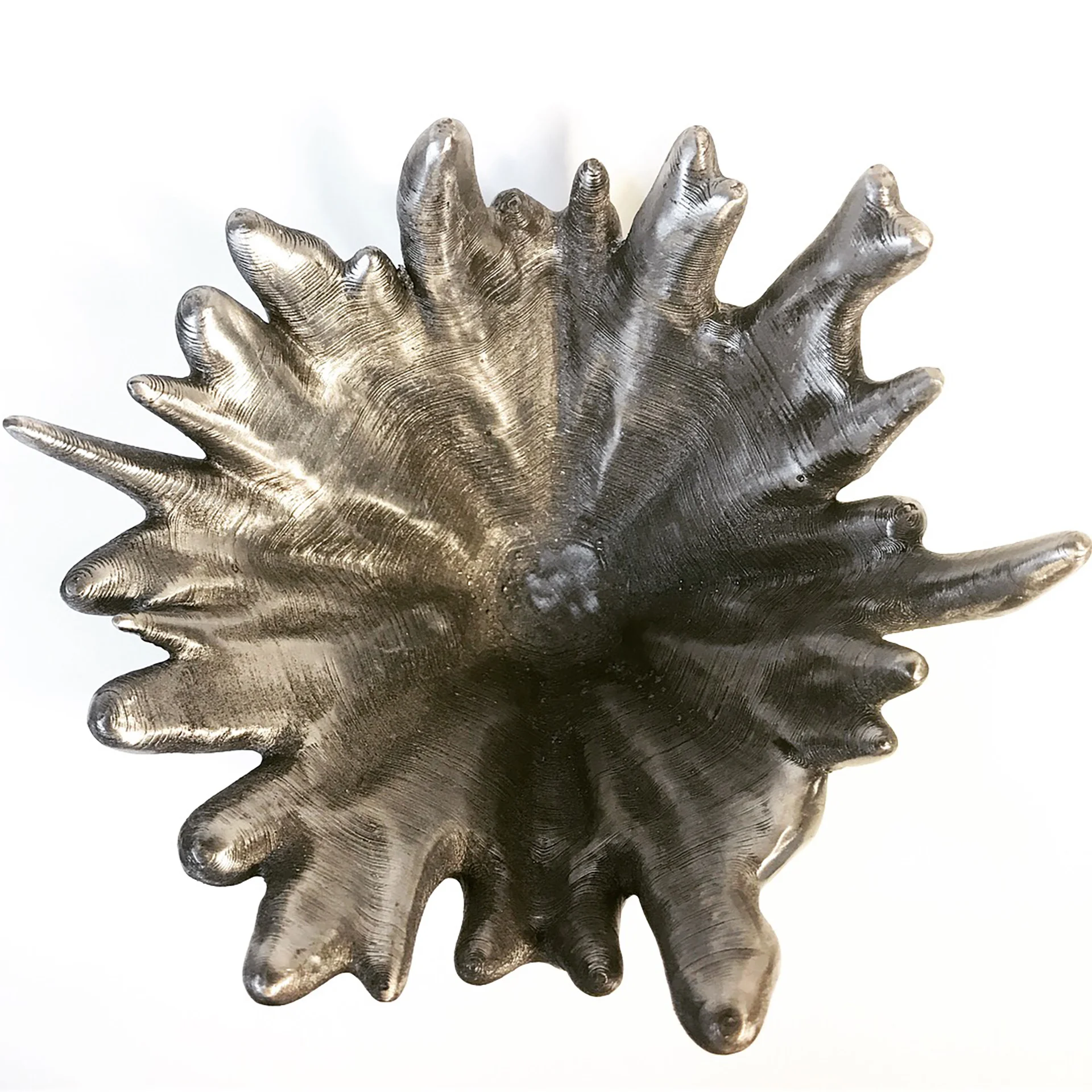 For dense materials such as molten bronze or iron this is the only moment they will ever experience such movement. The Splash Bowl preserves this moment in a material that will endure centuries of use.