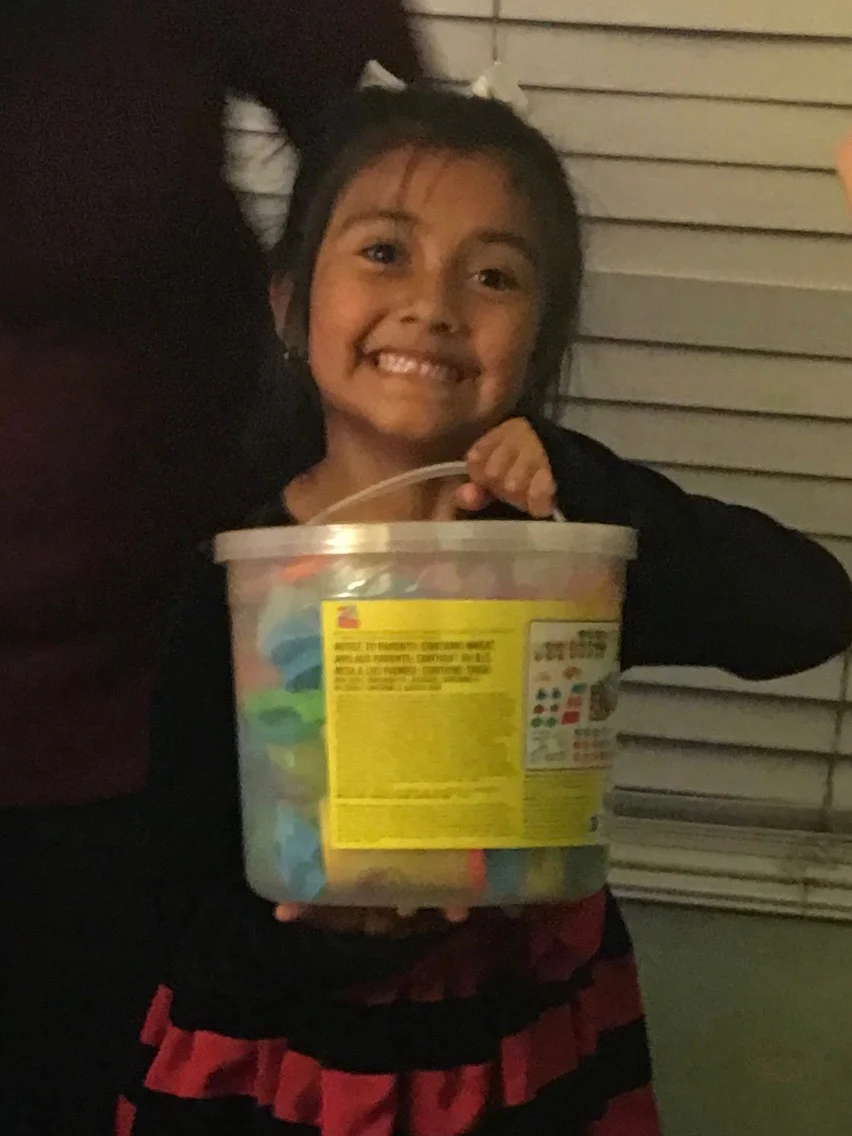 She is very happy with her bucket of chalk.