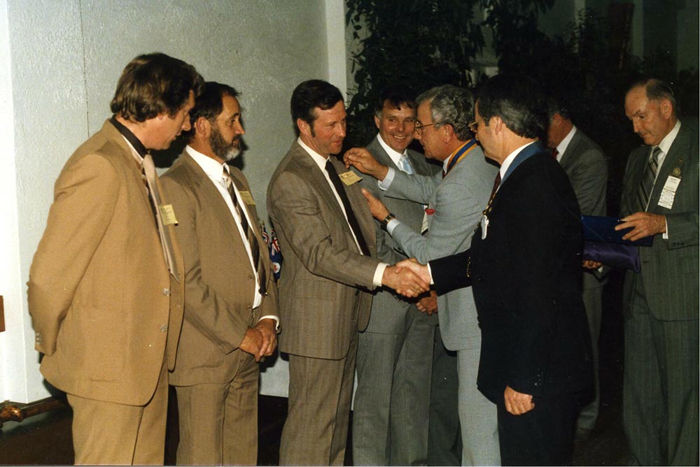 Charter members receive their membership badges from PDG Fred Edwards.