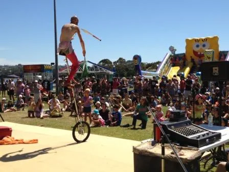 Unicyclist Juggler showing us his skills with long knives