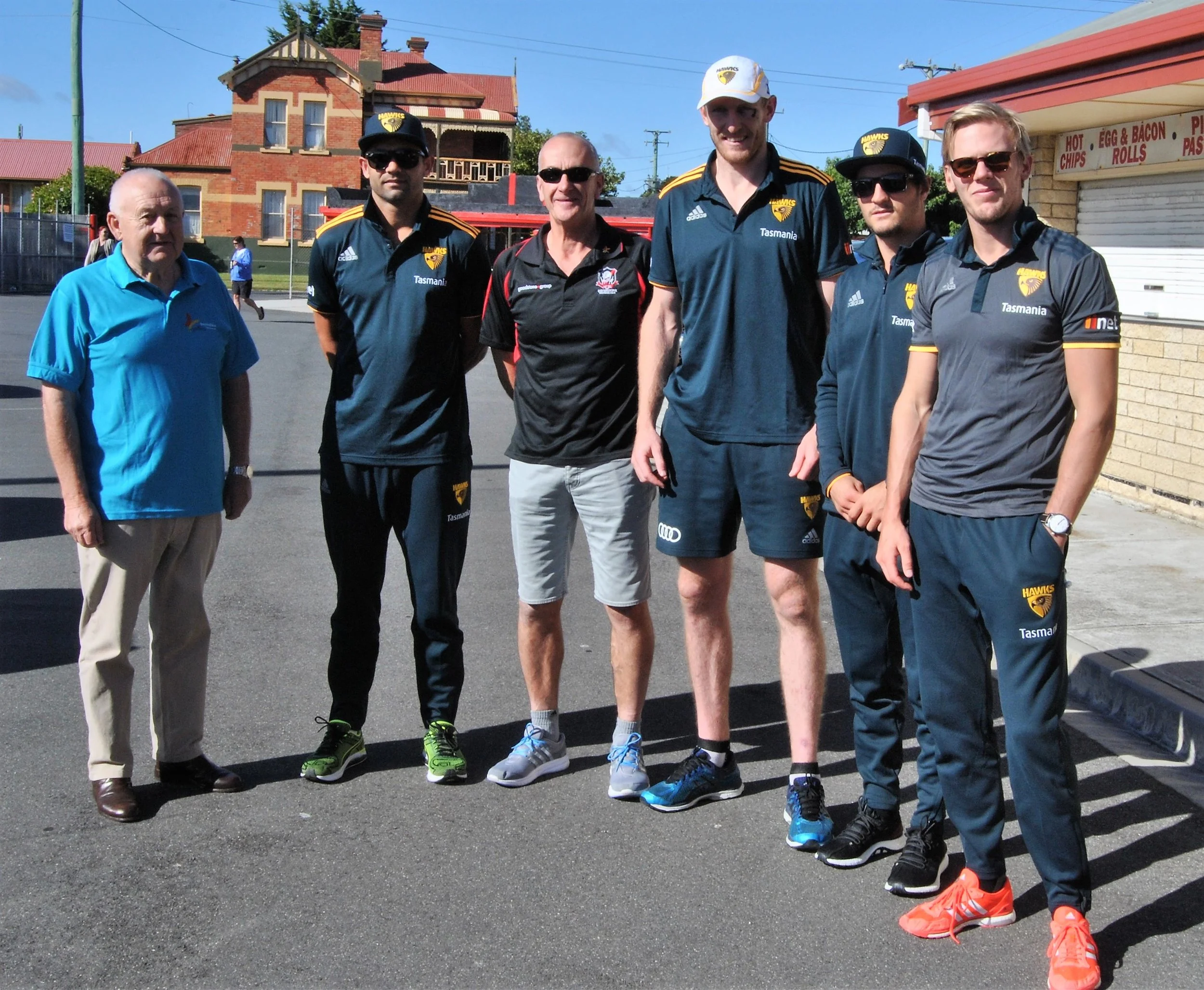 Rotarian Lindsay Morgan with Hawthorn players Ben McEvoy, Shaun Burgoyne, Will Langford and Kade Stewart, and support staff manager Kristian Hall