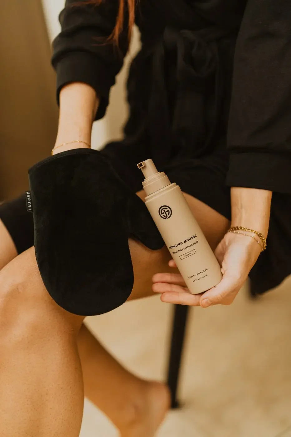 sjolie-applicator-mitt-model-applying-self-tanner-legs.jpg.webp