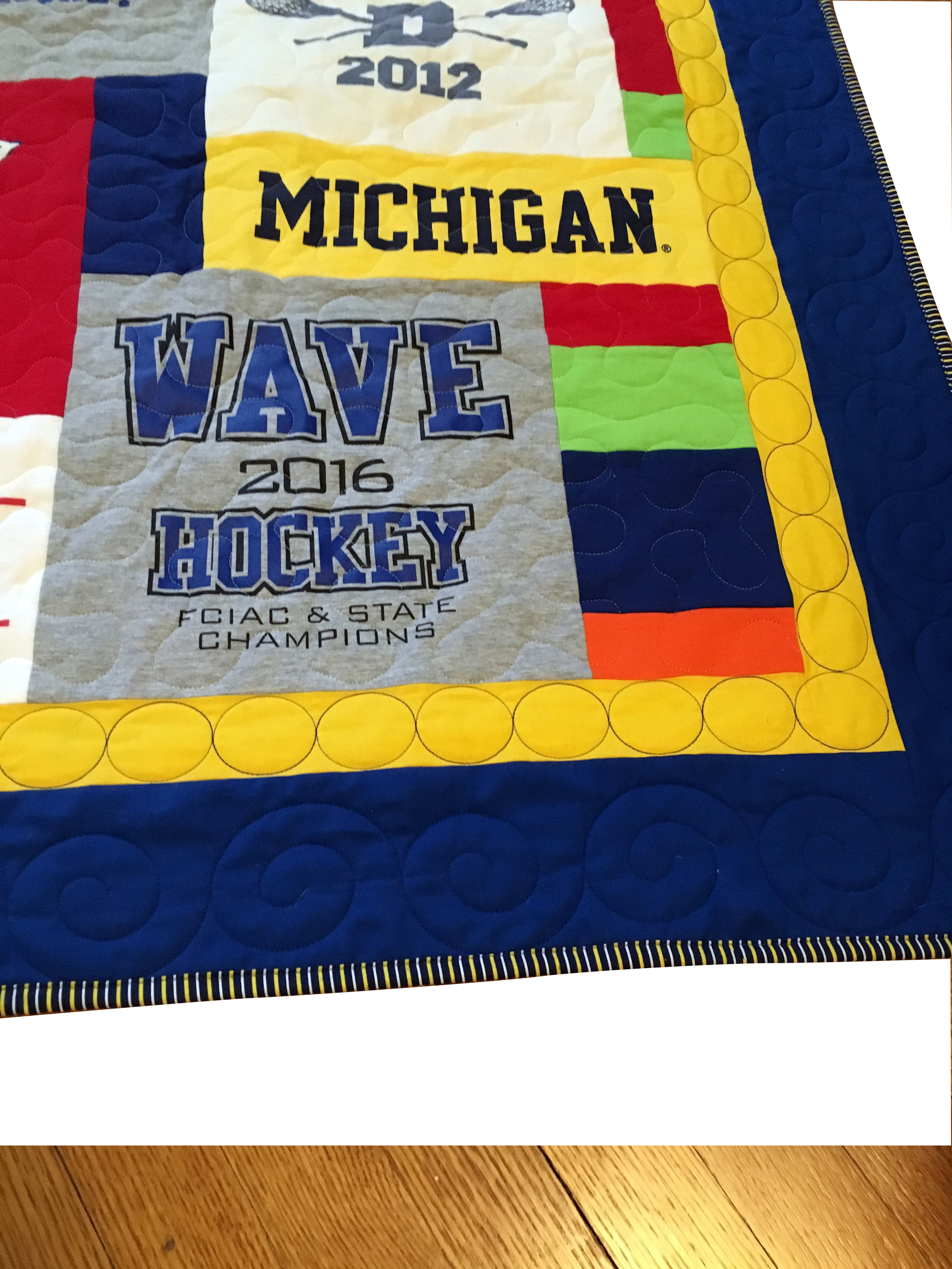 Double blue and yellow border with custom quilting and a state title
