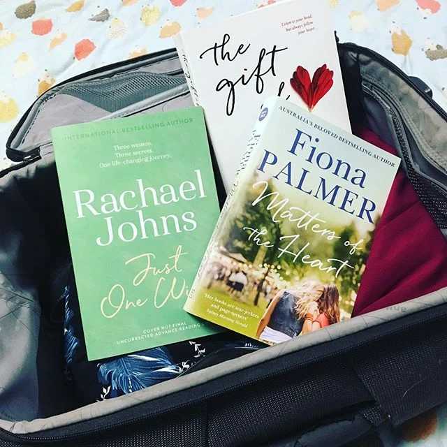 Trying to fit my stuff into carry on luggage for the RWA conference... Possum says I&rsquo;ve packed too many books and nothing crunchable. She has a point - but I can&rsquo;t leave these fab books behind! 😁🐶 @rachaeljohnsauthor @fiona_palmer @jose