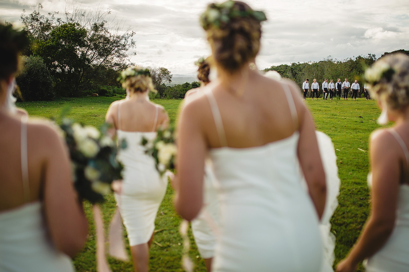 Bridesmaids and Groomsmen walking on the lawn at forest hall venue