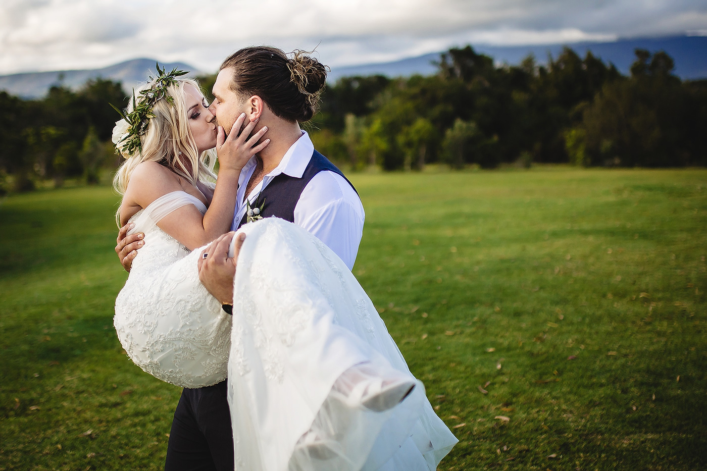 Groom carrying his bride and kiss during wedding portrait shoot