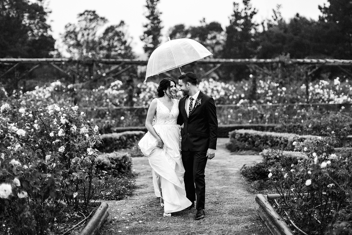 Rain Wedding portraits with umbrella in Style at the Rose Pavillion