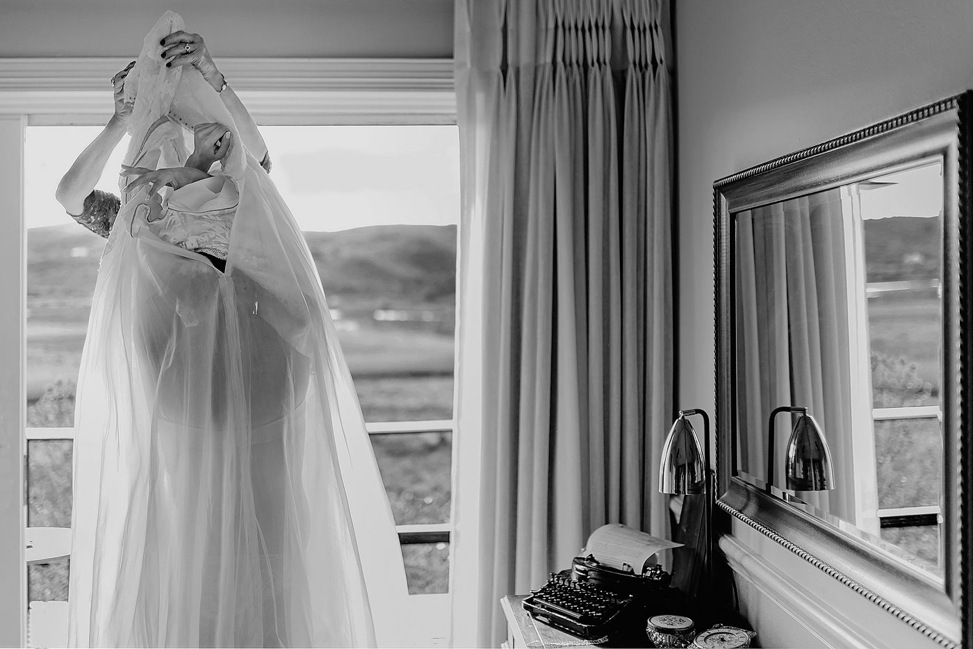 Bride putting on her wedding dress