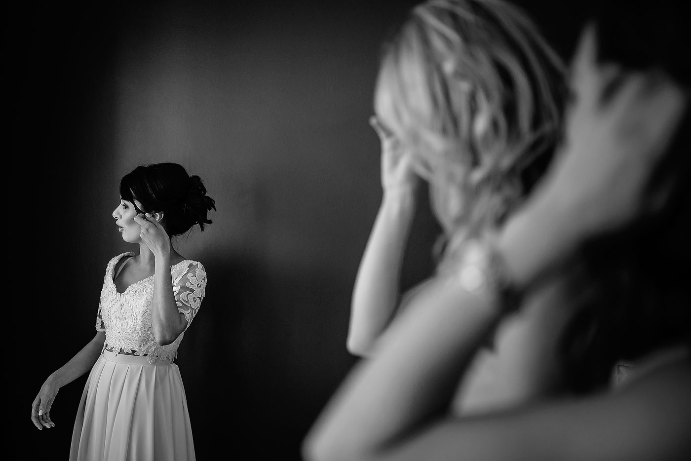 Bride putting on her Earrings in the Bridal Room