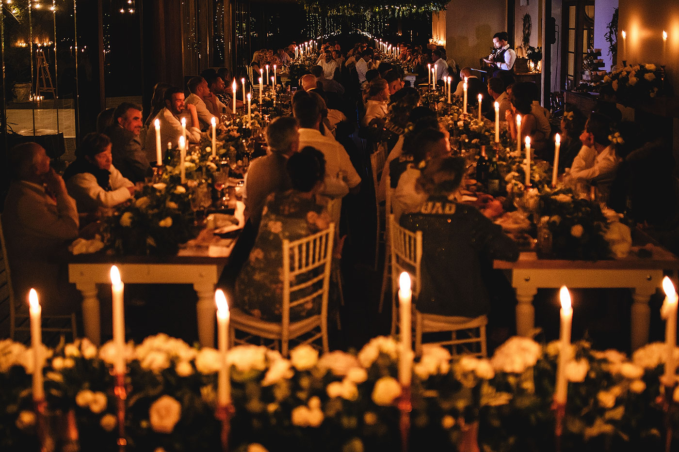 Groom speech with candles and guests listening