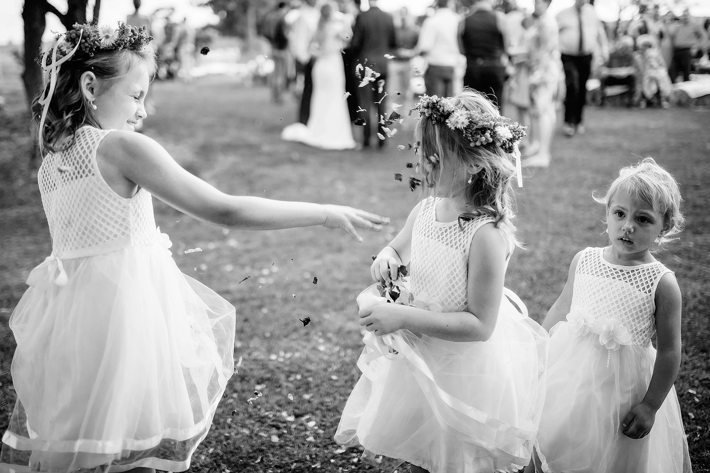 Wedding funny moment with flower girls and confetti.