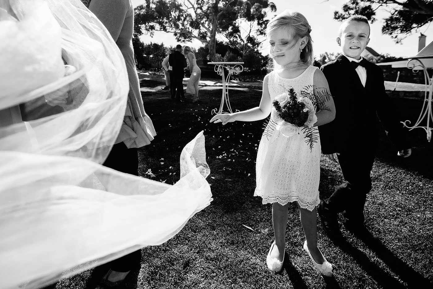 Kids at wedding playing with a veil