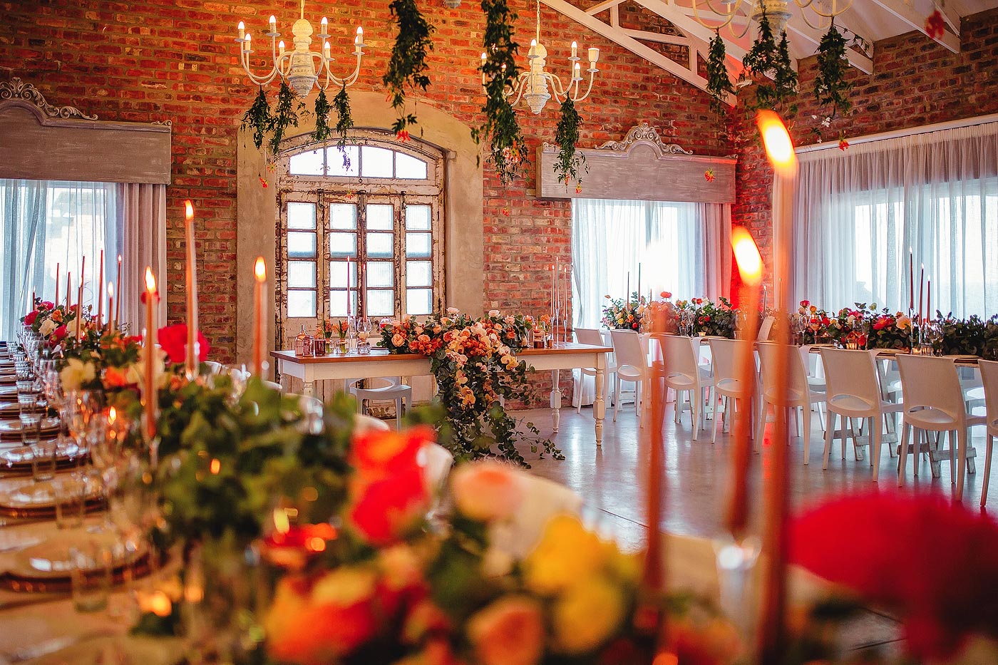 Warm inviting colour palette with extravagant wedding decor flowers.