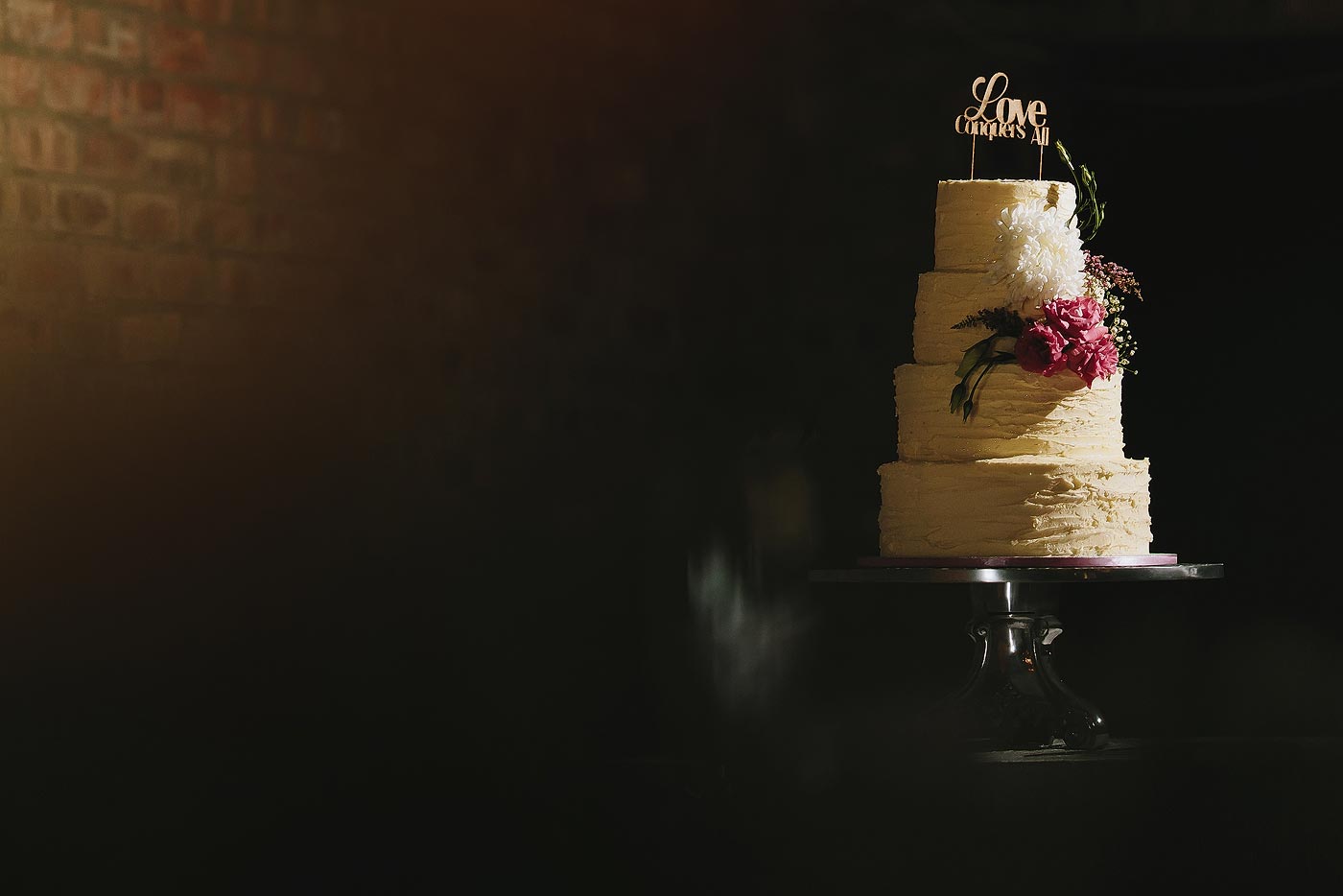 Tall Wedding Cake Details with flower and cake topper.