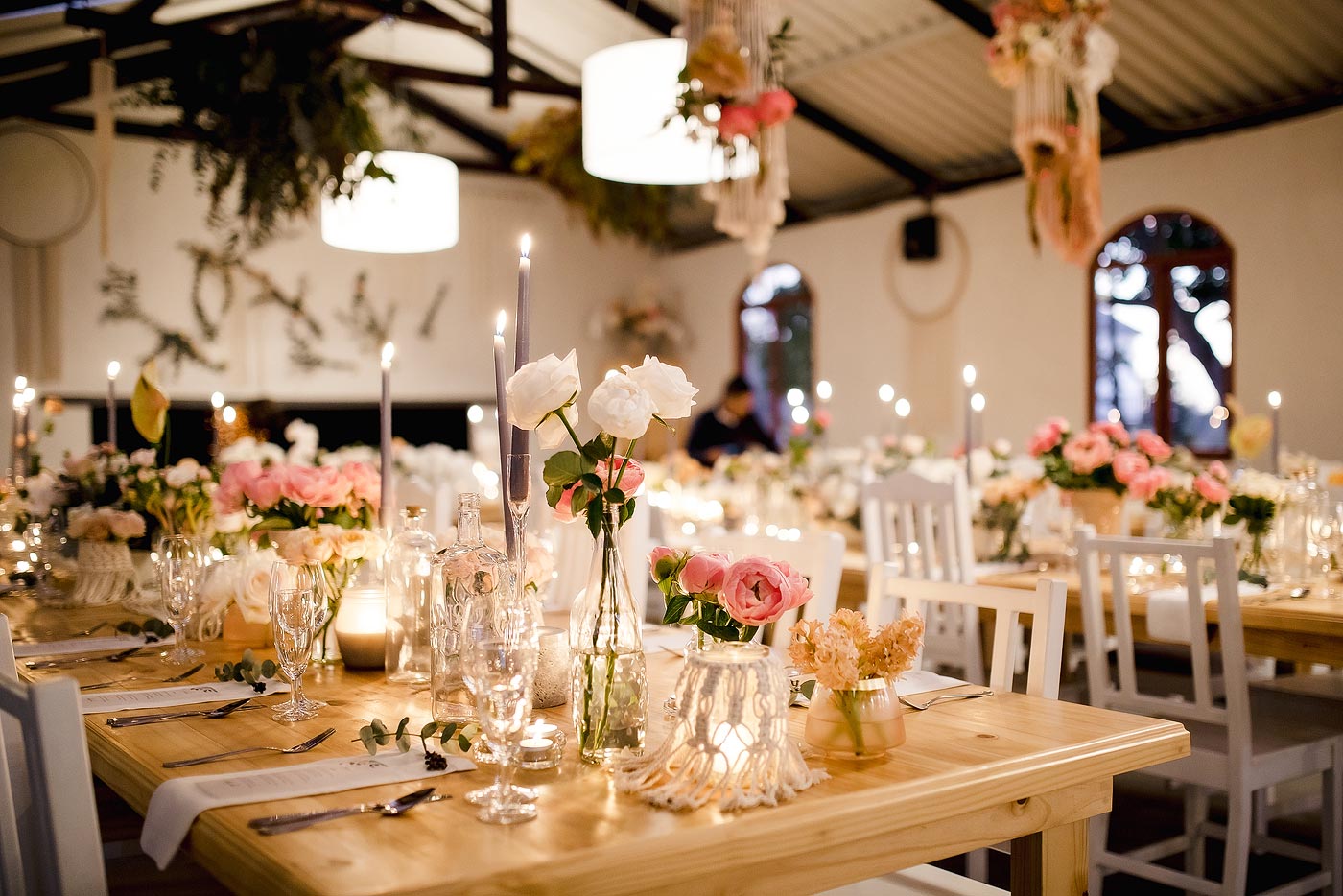 Elegant wedding flowers and reception decor with beautiful lighting.