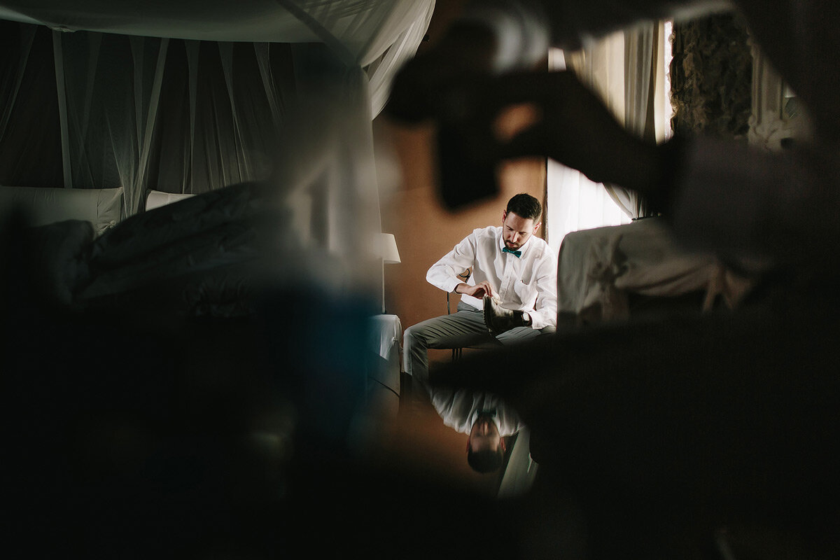 Groomsmen putting on their wedding shoes