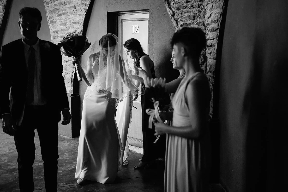 Bride on her way to the wedding ceremony with father and bridesmaids