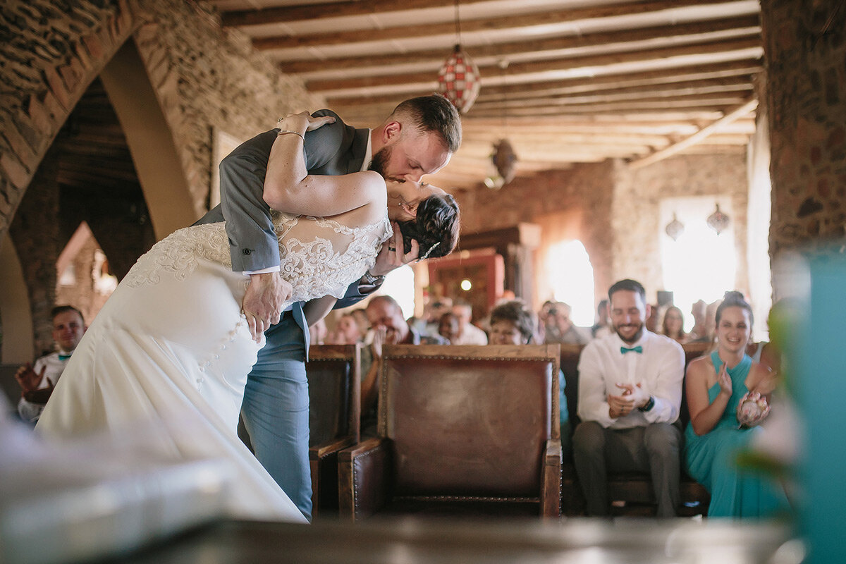 Wedding Ceremony dip kiss between bride and groom