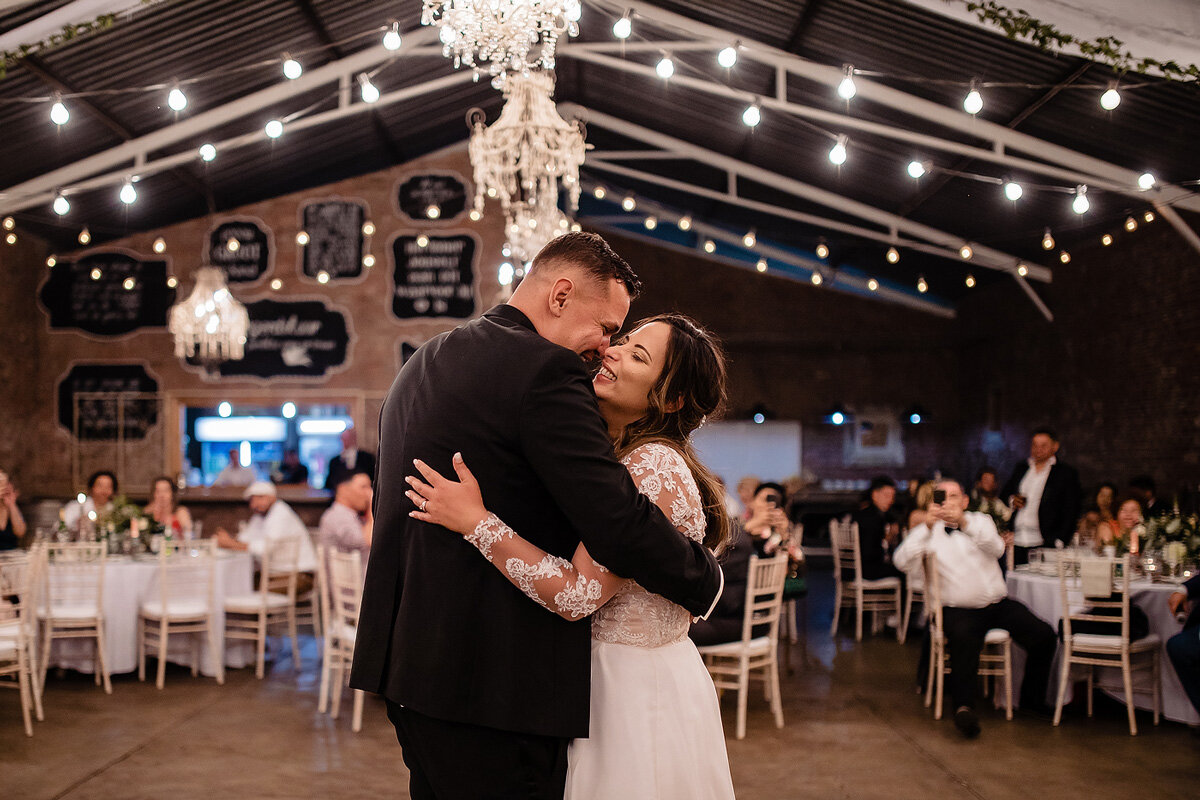 Bride and Groom wedding First dance with fairy lights in the reception venue