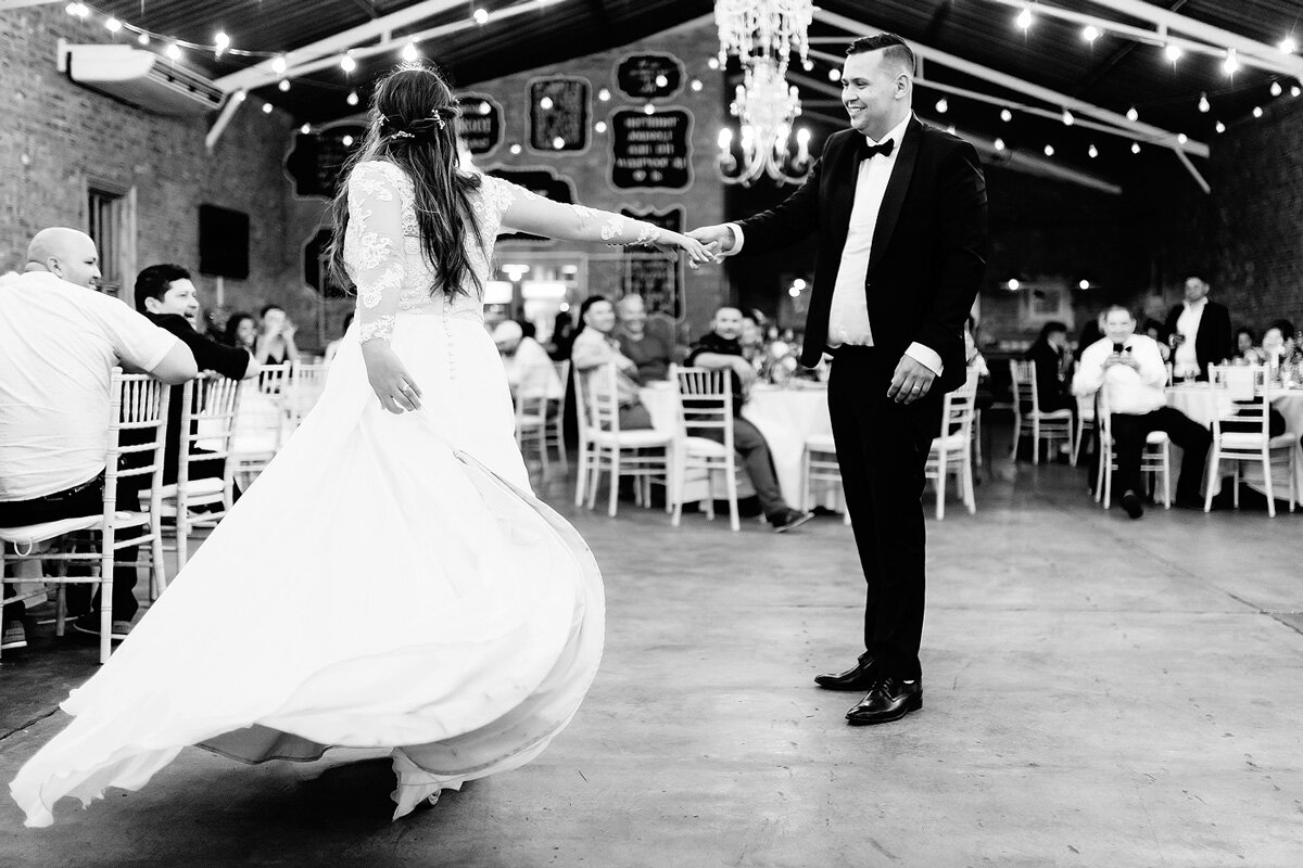Bride and Groom wedding First dance moves with fairy lights in the reception venue