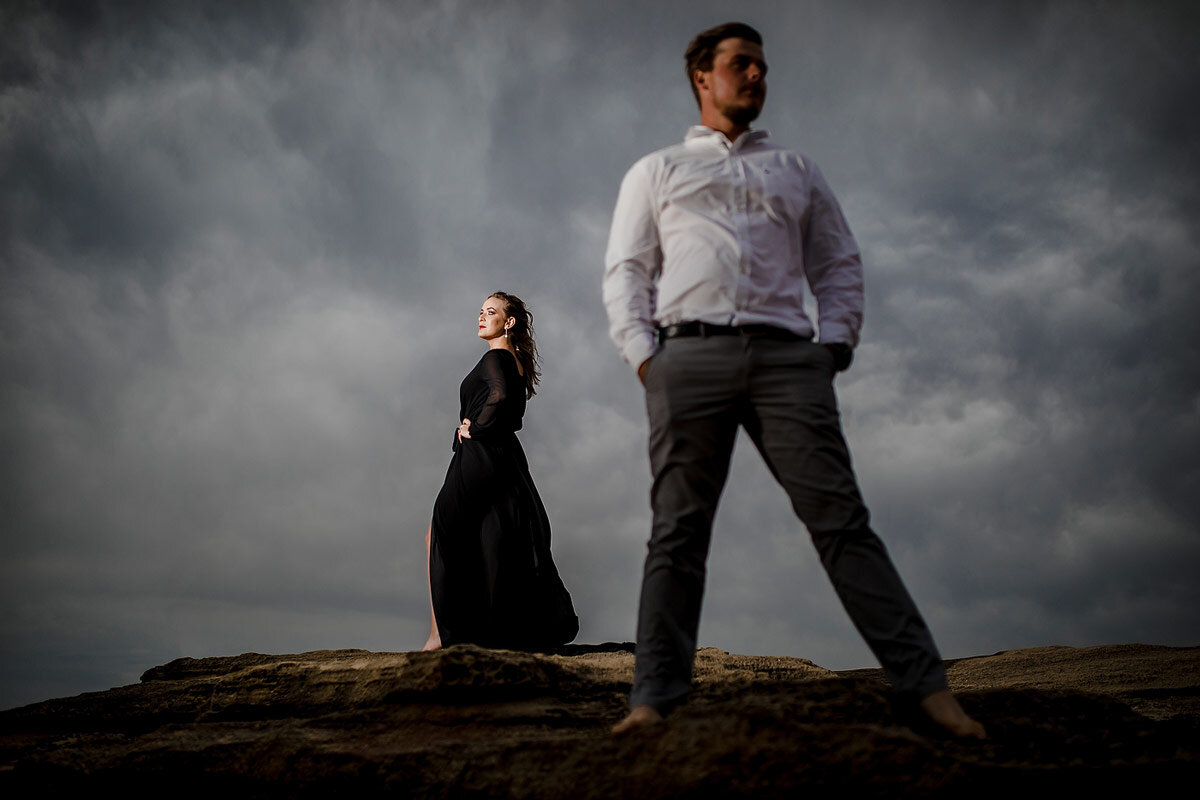 Creative Engagement Portraits on the beach with black dress in the Garden Route.