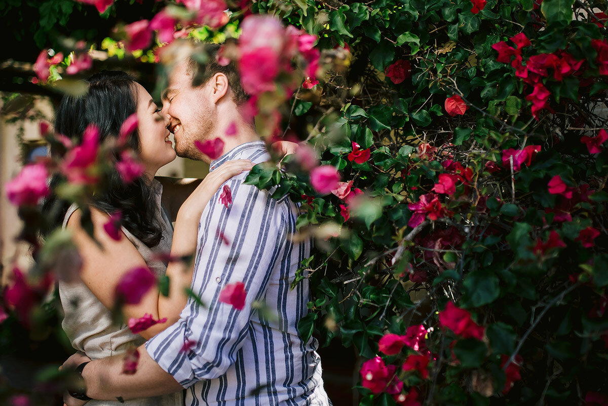 Romantic Couple Photo with Pink Flowers in their home Garden in Wilderness.