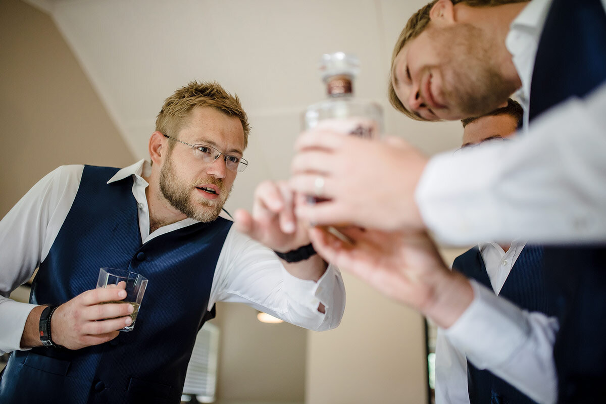 The groomsmen inspecting the Japanese Whisky before the wedding ceremony.