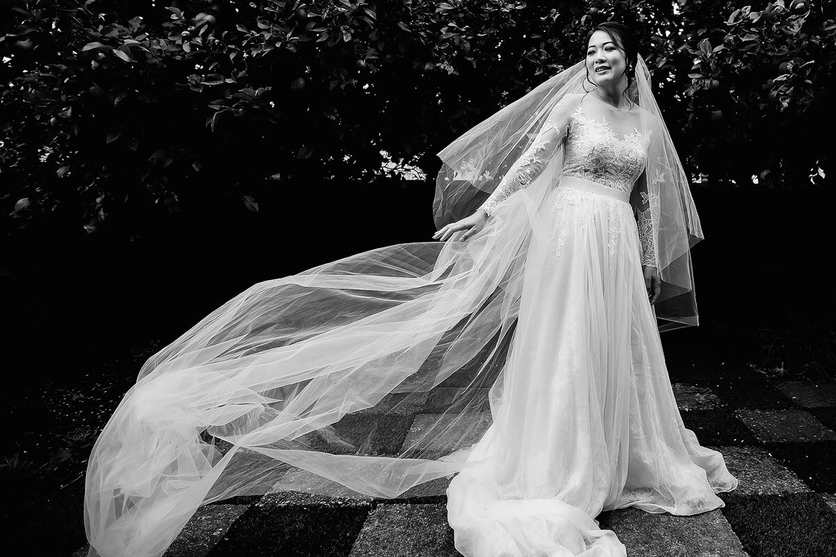  Bride with long veil flowing in the wind during a South African Wedding. 