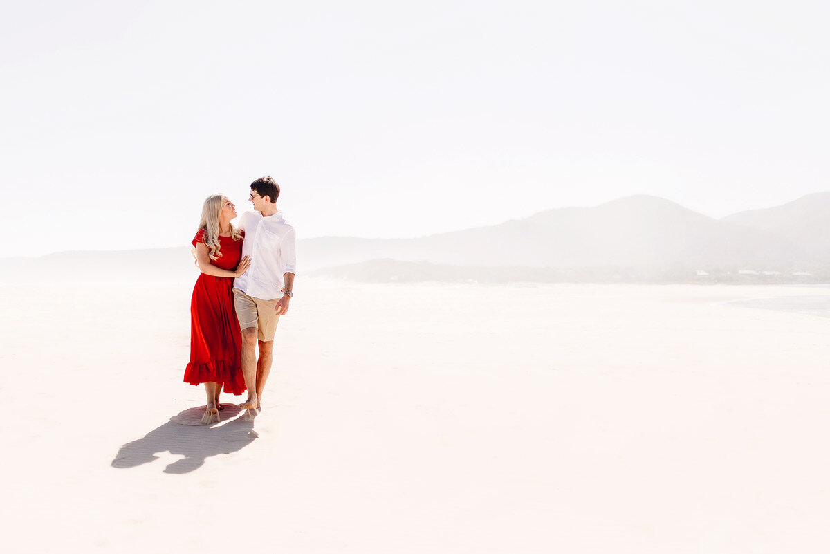 Elegant Couple Engagement Portraits with a Red Dress on the beach in South Africa.